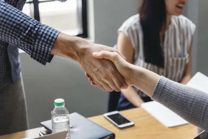 Business people shaking hands in agreement